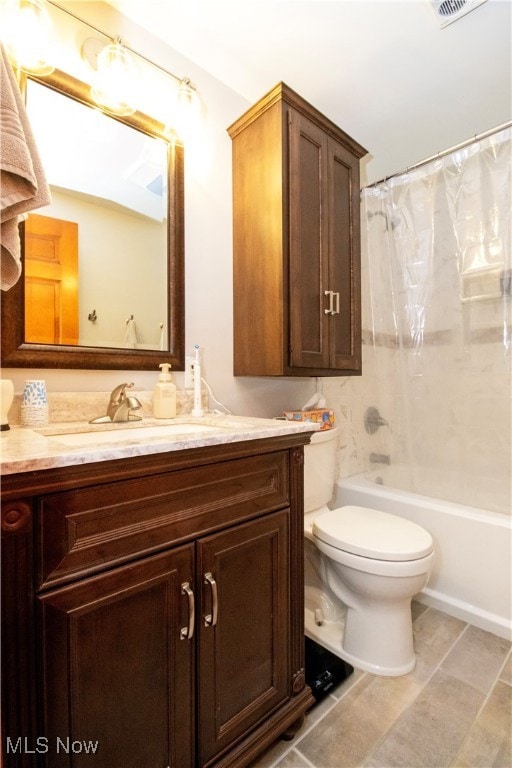 full bathroom featuring shower / tub combo with curtain, tile patterned floors, vanity, and toilet