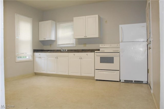 kitchen featuring white appliances, sink, and white cabinets