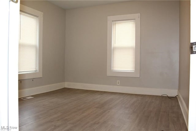 spare room featuring dark hardwood / wood-style flooring