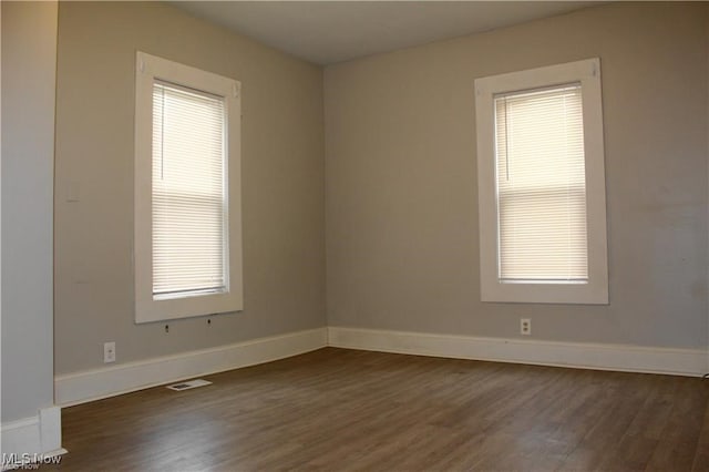 empty room featuring dark hardwood / wood-style flooring