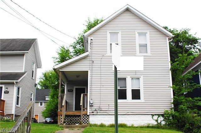 rear view of property with a yard