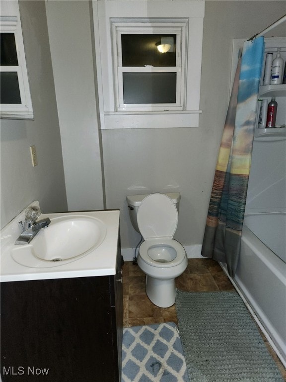 full bathroom featuring tile patterned flooring, shower / bathtub combination with curtain, vanity, and toilet