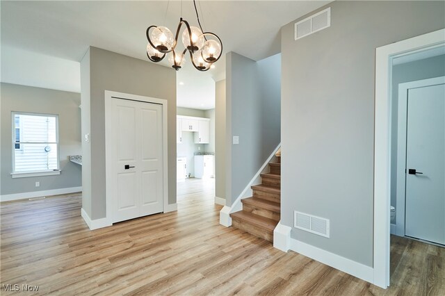 interior space with light hardwood / wood-style floors and a chandelier