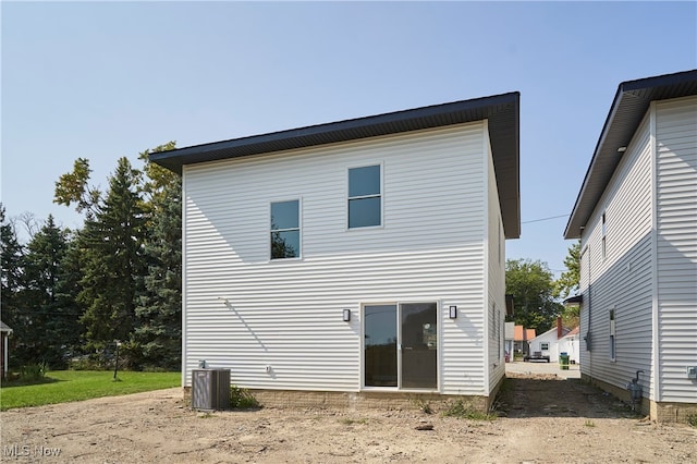 rear view of house featuring central air condition unit