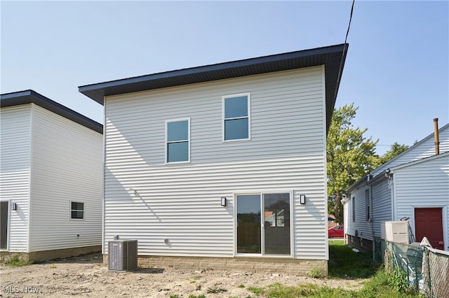 rear view of house featuring central AC unit