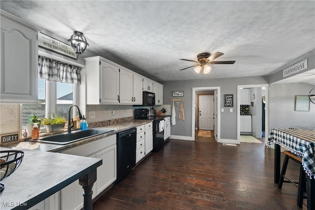 kitchen with black appliances, white cabinets, sink, and dark hardwood / wood-style flooring