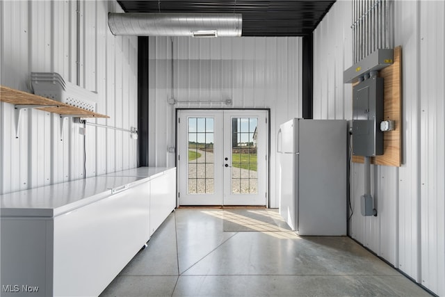 doorway featuring a high ceiling, electric panel, and french doors