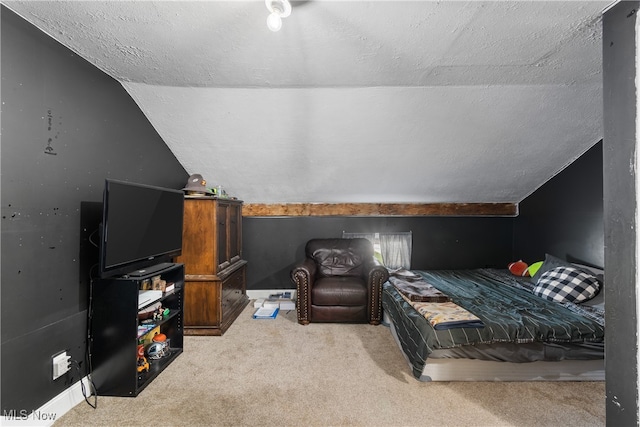 carpeted bedroom with vaulted ceiling and a textured ceiling