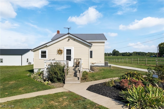 bungalow with a front lawn and a rural view