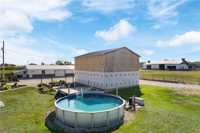 view of swimming pool featuring a lawn