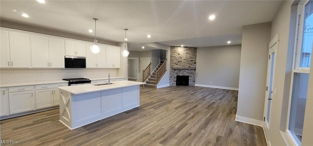 kitchen with white cabinetry, sink, an island with sink, and appliances with stainless steel finishes