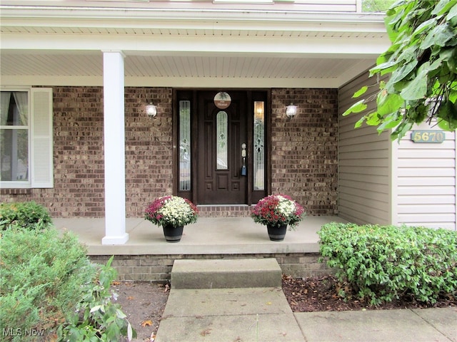 view of exterior entry featuring a porch