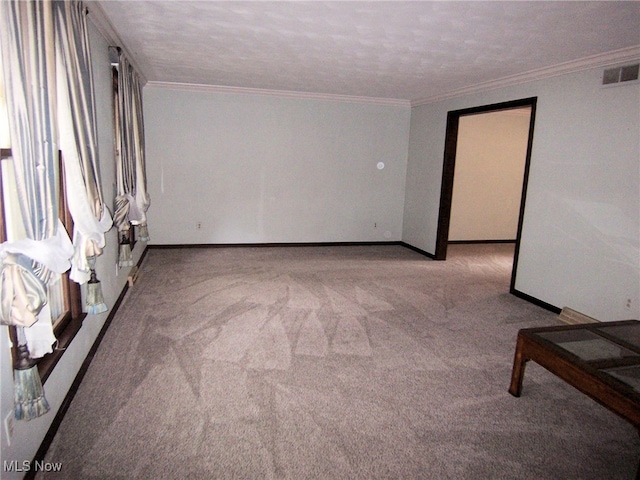 carpeted spare room featuring a textured ceiling and crown molding