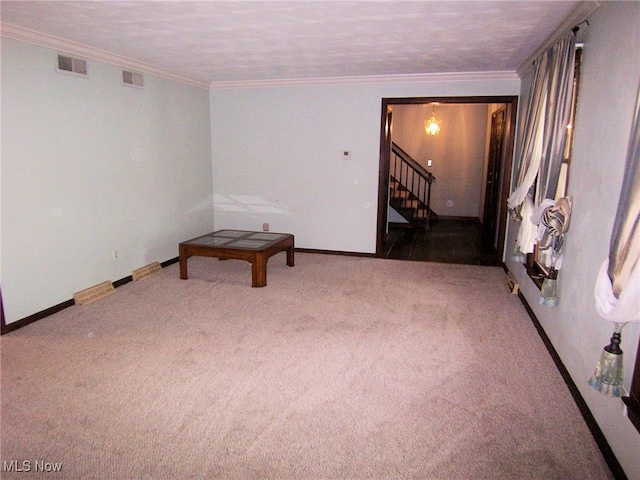 carpeted spare room featuring a textured ceiling and ornamental molding