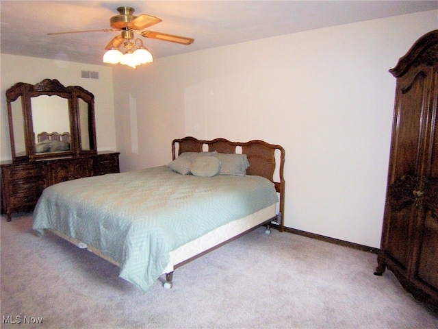 bedroom with ceiling fan and light carpet