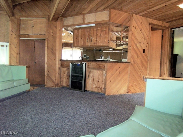 kitchen with wooden ceiling, wooden walls, and dark carpet