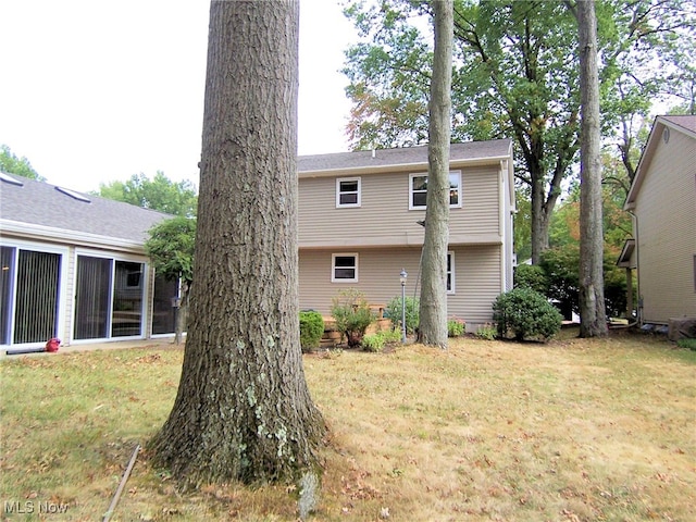 rear view of house with a yard