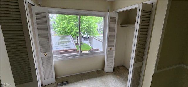 unfurnished bedroom with multiple windows and light colored carpet