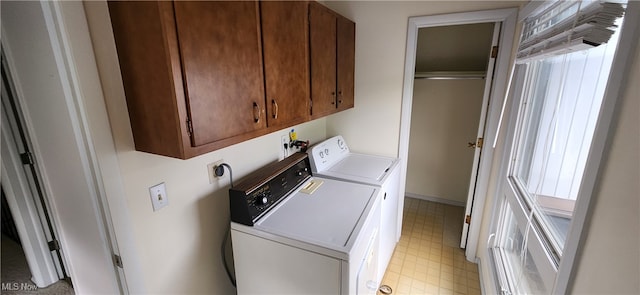 laundry area featuring washer and dryer and cabinets