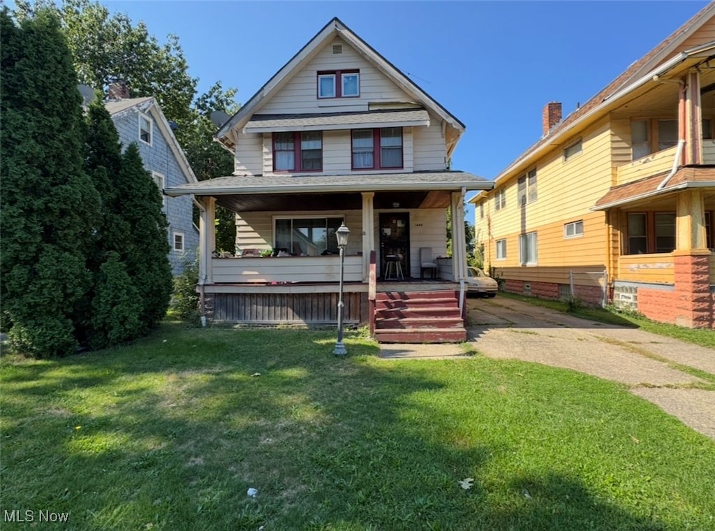 bungalow-style home with a front lawn and a porch