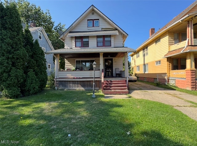 bungalow-style home with a front lawn and a porch