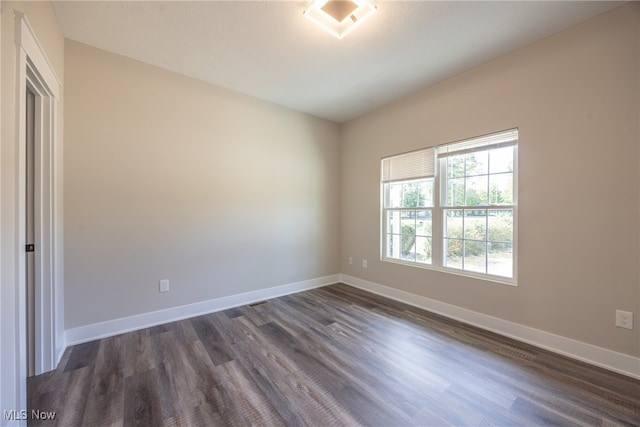 empty room with dark hardwood / wood-style floors