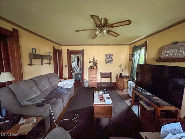 living room with ceiling fan and crown molding