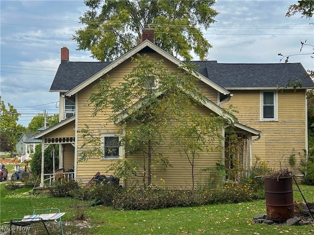 view of side of home with a yard