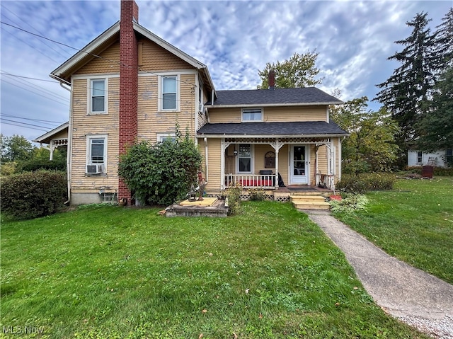 view of property featuring a porch and a front yard