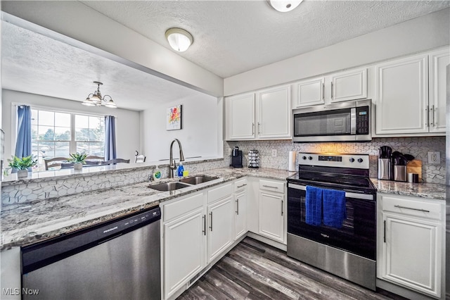 kitchen featuring white cabinetry, appliances with stainless steel finishes, and sink