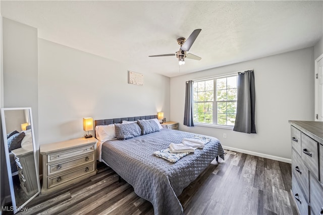 bedroom with ceiling fan and dark hardwood / wood-style flooring