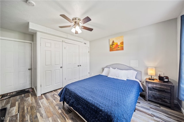 bedroom with ceiling fan and wood-type flooring