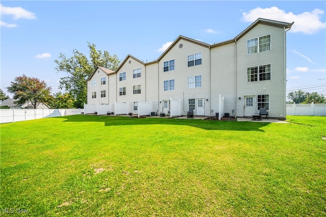 back of property featuring a lawn and a patio