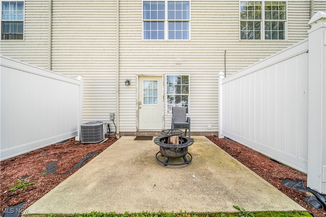 view of patio featuring central AC and a fire pit