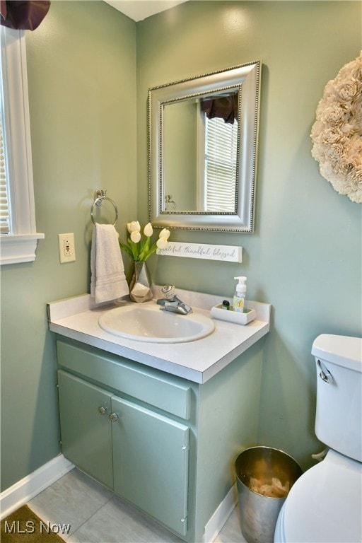 bathroom with vanity, toilet, and tile patterned floors