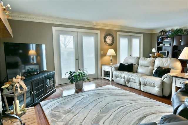 living room featuring french doors, hardwood / wood-style flooring, crown molding, and a healthy amount of sunlight