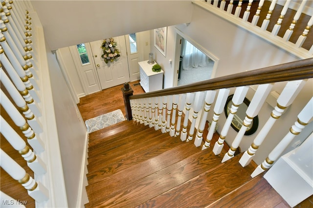 staircase with hardwood / wood-style flooring