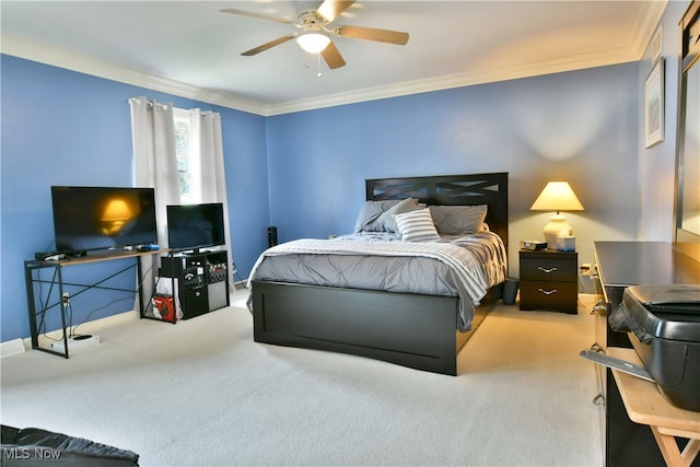 carpeted bedroom featuring ceiling fan and crown molding