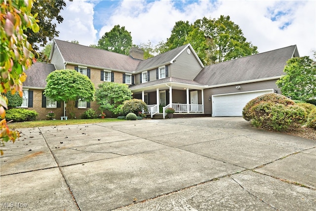 view of front of home with a porch and a garage