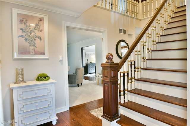 interior space featuring wood-type flooring and crown molding