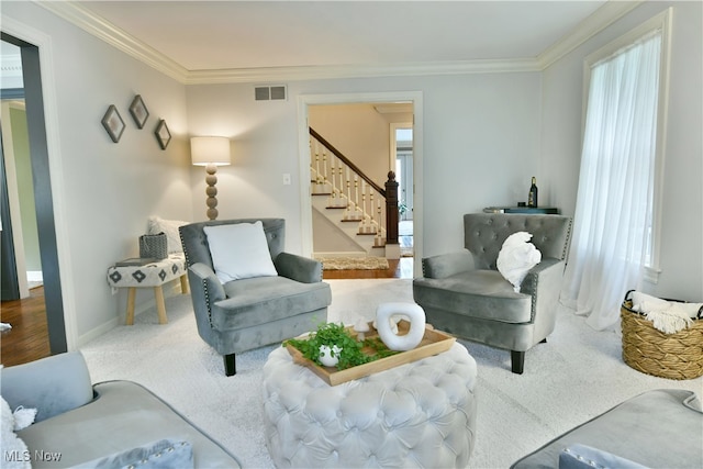 carpeted living room featuring ornamental molding and a wealth of natural light