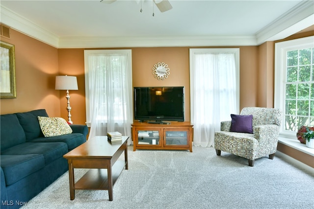 living room with ornamental molding, ceiling fan, and carpet floors