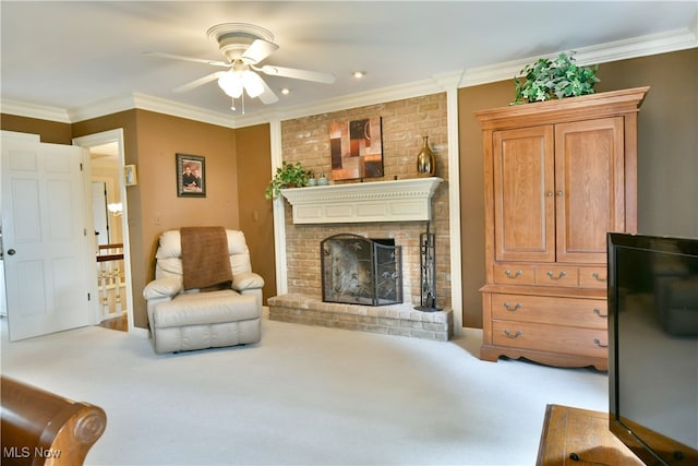 living room featuring ceiling fan, light colored carpet, a fireplace, and ornamental molding