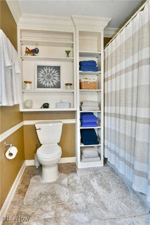 bathroom with toilet and crown molding