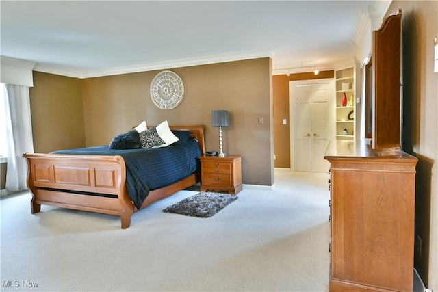 carpeted bedroom featuring ornamental molding and rail lighting