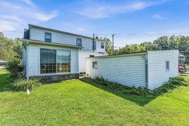 rear view of property with a yard