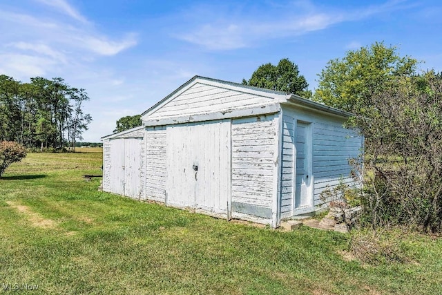 view of outdoor structure featuring a lawn