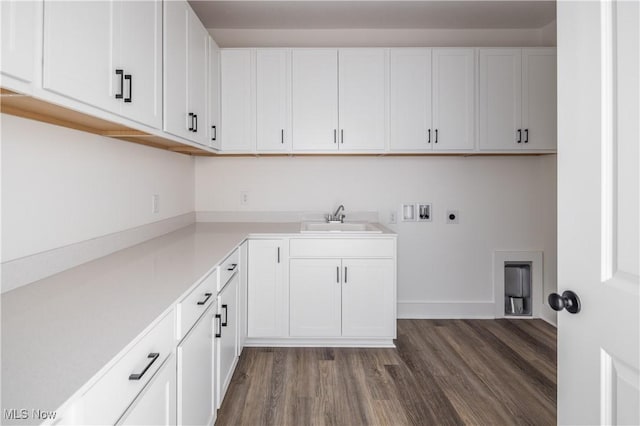 laundry room featuring sink, dark wood-type flooring, electric dryer hookup, hookup for a washing machine, and cabinets