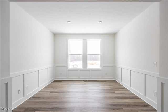 spare room with hardwood / wood-style floors