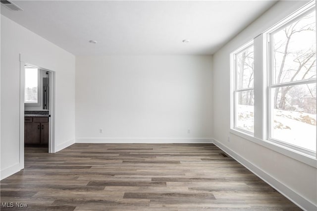 unfurnished room with hardwood / wood-style flooring